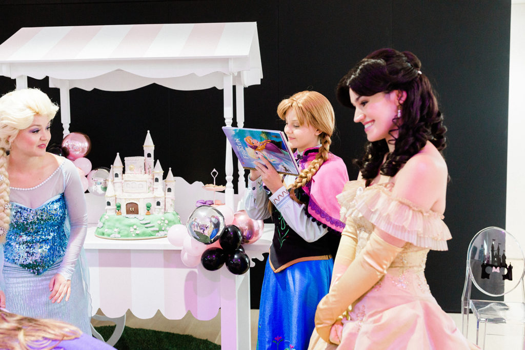 Ana reads storybook at princess birthday